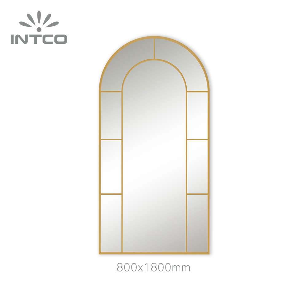 Gold metal wall mirror with arched window pane frame